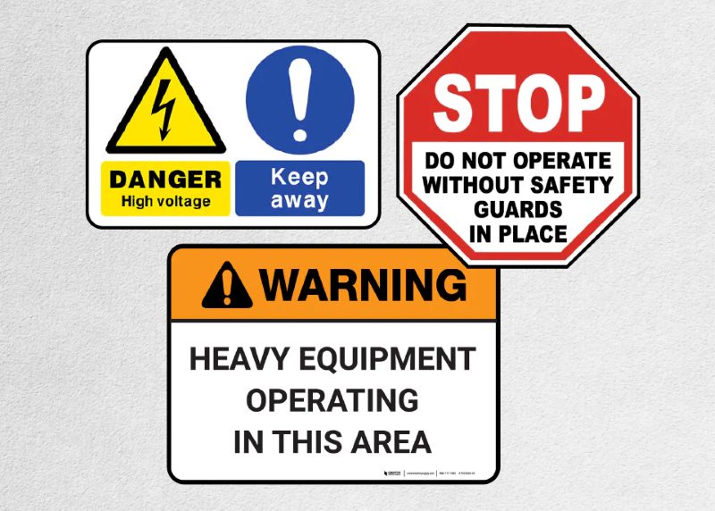 Safety warning signs showing high voltage danger, restricted access, and heavy equipment operation